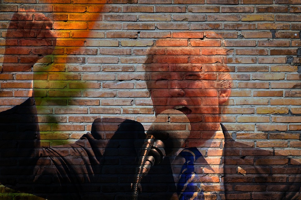 Donald Trump skriker i en mikrofon och höjer näven i luften.